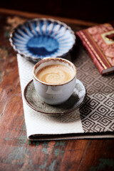 Cup of coffee on wooden background. Soft focus.