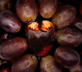 close up of a bunch of red grapes and strawberries with syrup
