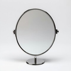 An elegant oval mirror on a chrome stand, reflecting simplicity and style for modern home decor.