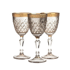 Three elegant, gold-rimmed crystal glasses.