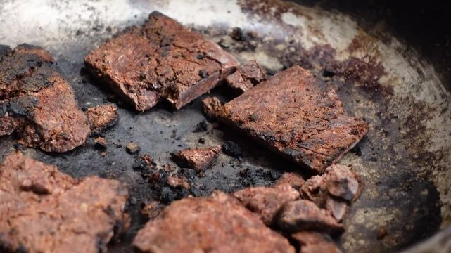 The process of frying shrimp paste before mixing it with food