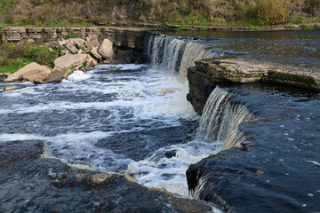 At the waterfall on the Tosna River on an October day. Leningrad Region, Russia