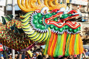 Chinese dragon dance show on street in the Chinese New Year festival.Chinese dragon costume used during Chinese New Year celebration in China town.Holidays and celebrations concept. Selective focus.