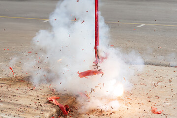Red firecrackers exploding in the street for the chinese new year celebration day.Chinese New Year...