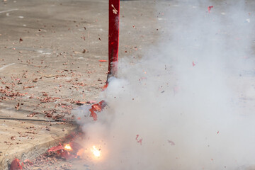 Red firecrackers exploding in the street for the chinese new year celebration day.Chinese New Year...