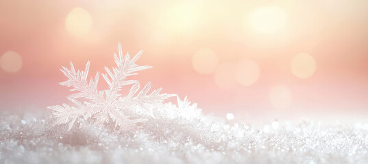 Delicate ice crystal snowflake on sparkling snow with warm bokeh background