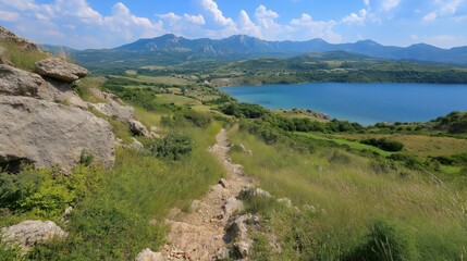 A mountain range with a lake in the distance