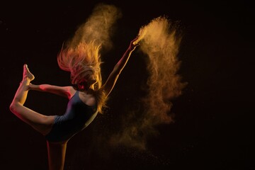 Dynamic dancer creates a mesmerizing spray of colored powder in motion