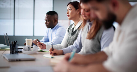 Studying In Classroom At Campus. Students Writing