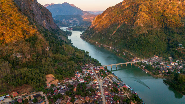 drone sunset of Nong Khiaw village in Luang Prabang Province of northern Laos on the Nam Ou River scenic mountain landscape paradise in south east asia aerial 