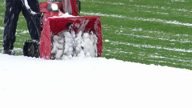 Snow removal from football field using snow blower