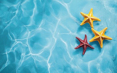 Vibrant red and yellow starfish resting on rippling clear blue water, evoking summer, tropical vibes, and marine life.

