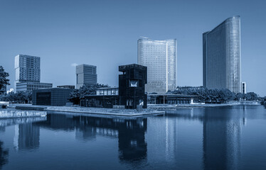Naklejka premium Modern Urban Waterfront with Reflective Architecture in Blue Tones