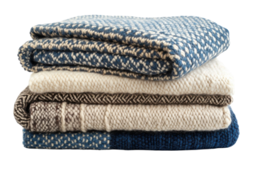 Cozy stacked blankets in various colors and patterns for a warm home atmosphere during winter evenings