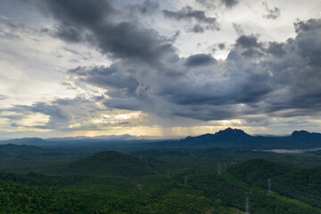 Obraz premium Aerial view Arcus cloud or shelf cloud: rainstorms, and black clouds moving over the mountains in northern Thailand's Mae Mo district, Lampang.