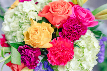 Close-up of vibrant wedding bouquet with colorful flowers.