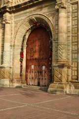 Naklejka premium Wooden door of a colonial church in Oaxaca City, Mexico