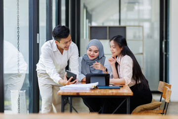 Financial Advisor discussion group of four happy young asian corporate people teammates meeting...
