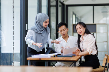 Financial Advisor discussion group of four happy young asian corporate people teammates meeting...