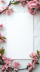 Obraz premium A blank white sheet surrounded by delicate pink cherry blossom branches, creating a serene and aesthetic composition.