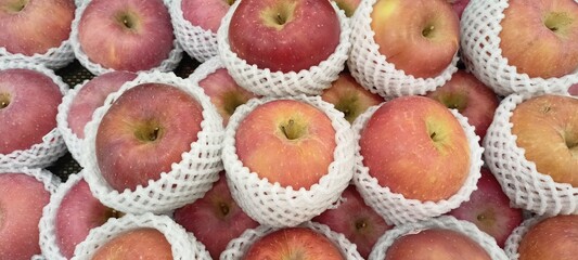 red apples on the supermarket fruit shelf