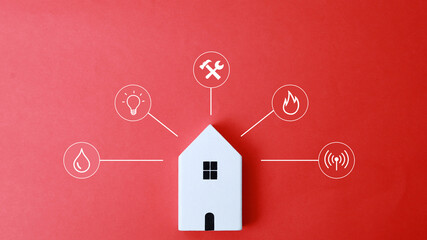 Miniature house and symbols of public utilities on a yellow background Top view Flat lay