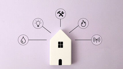 Miniature house and symbols of public utilities on a yellow background Top view Flat lay