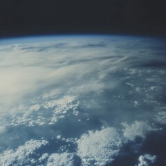 Fototapeta premium Stunning view of Earth from space, showing a blue planet with white clouds and dark space.
