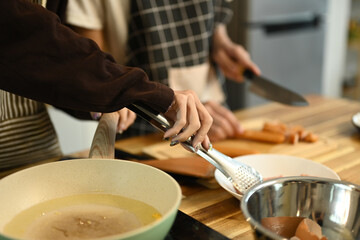 Close up of a gay couple preparing a meal in the kitchen