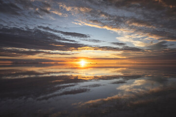 reflections in Uyuni salt field at sunset