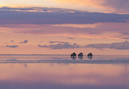 cars over salt field with water at down
