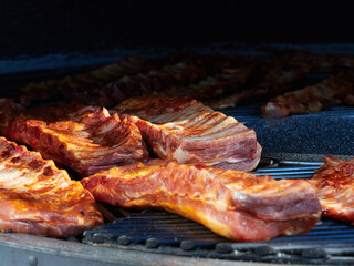 The ribs are grilled on a rotating grill