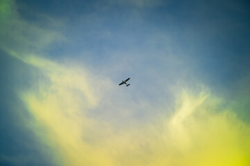 Low angle view of airplane flying against blue sky backgrounds at dusk