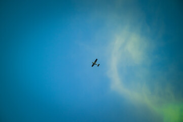 Low angle view of airplane flying against blue sky backgrounds at dusk