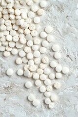 White tablets scattered on a textured surface in a bright setting
