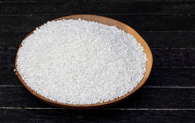 Organic Sago or Sabudana in a Wooden Bowl Isolated on Black Background