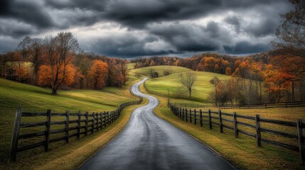 Fototapeta premium A country road flanked by rustic wooden fences and rolling green hills under a cloudy sky