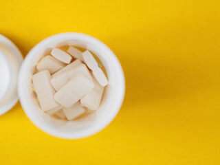 Pills of different shapes and colors on a spectacular background: an illustration of pharmaceuticals and the importance of medicines for health.
