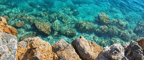 Clear turquoise water over rocky seabed.