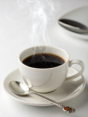 Hot black coffee in a white cup on a white background