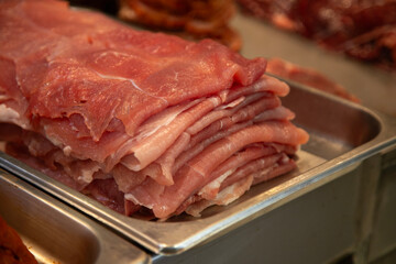 Cecina from Oaxaca. Mexican sliced cured pork or beef meat from Oaxaca displayed in a butcher shop in a mexican food market.