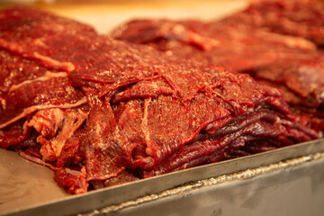 Cecina from Oaxaca. Mexican sliced cured pork or beef meat from Oaxaca displayed in a butcher shop...