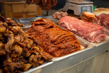 Cecina from Oaxaca. Mexican sliced cured pork or beef meat from Oaxaca displayed in a butcher shop in a mexican food market.