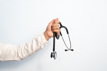 Female doctor hand holding stethoscope isolated white background. Medical and hospital equipment...
