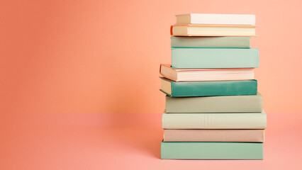 Fototapeta premium pastel books pile empty pink background