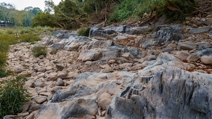A line of boulders in various colors and sizes, stacked and arranged in a row.