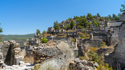 Destroyed walls of houses in abandoned town or village Kayakoy, neighbourhood of municipality and district of Fethiye, Mugla Province, Turkey