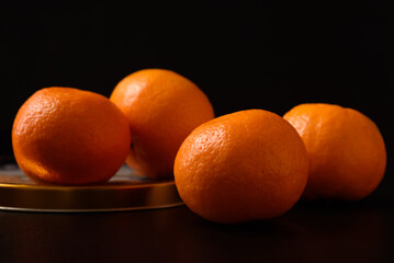 Fresh mandarin oranges healthy fruit on black background.
