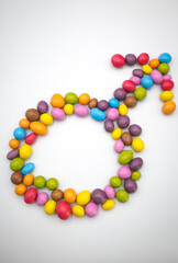 Male gender, symbol, sign. Colorful candies.
