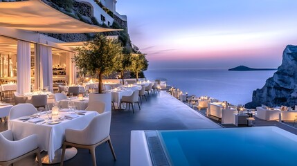 Fototapeta premium santorini sunset: luxury restaurant & infinity pool - luxury travel
